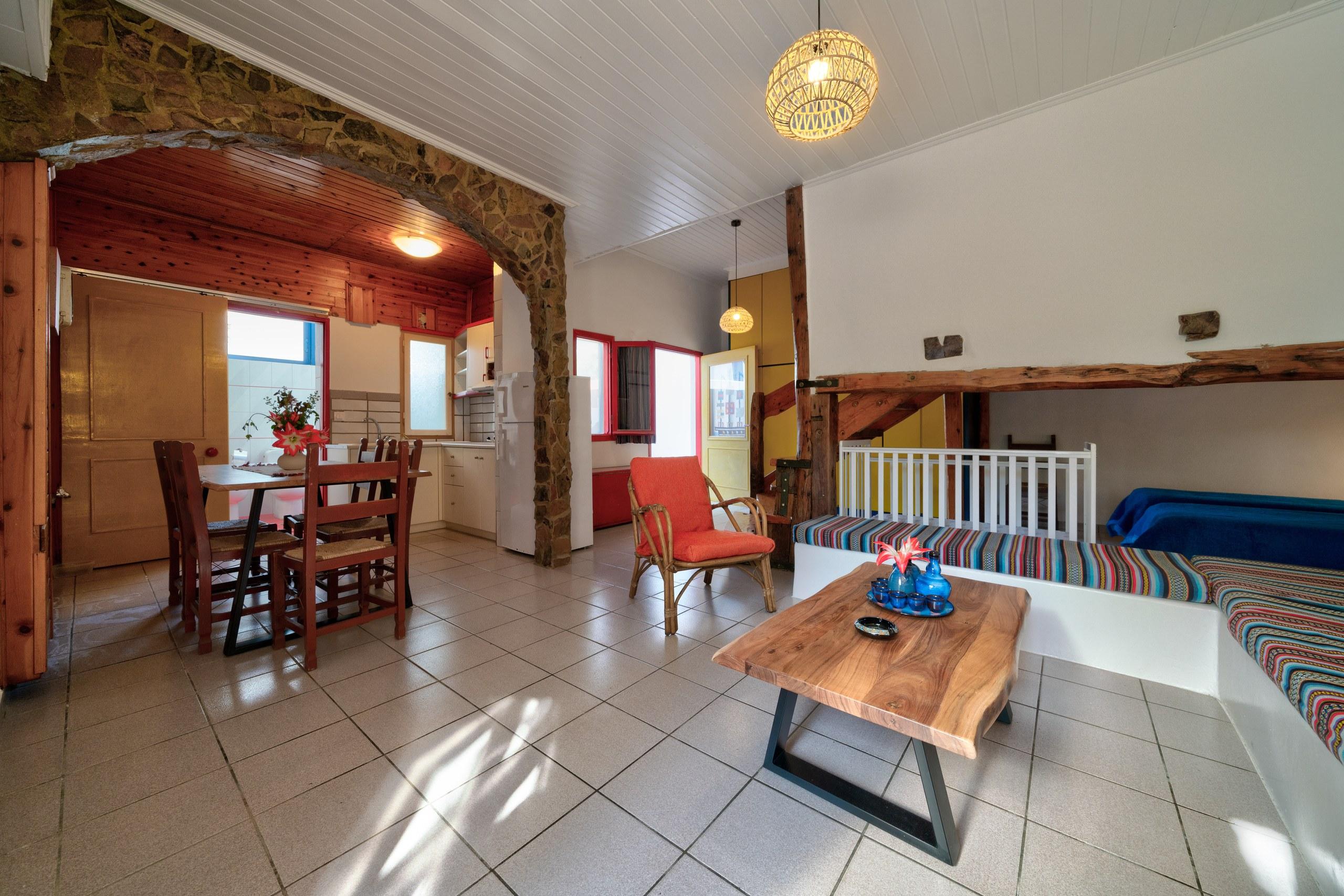 A split-level garden apartment with a timber staircase and a full kitchen