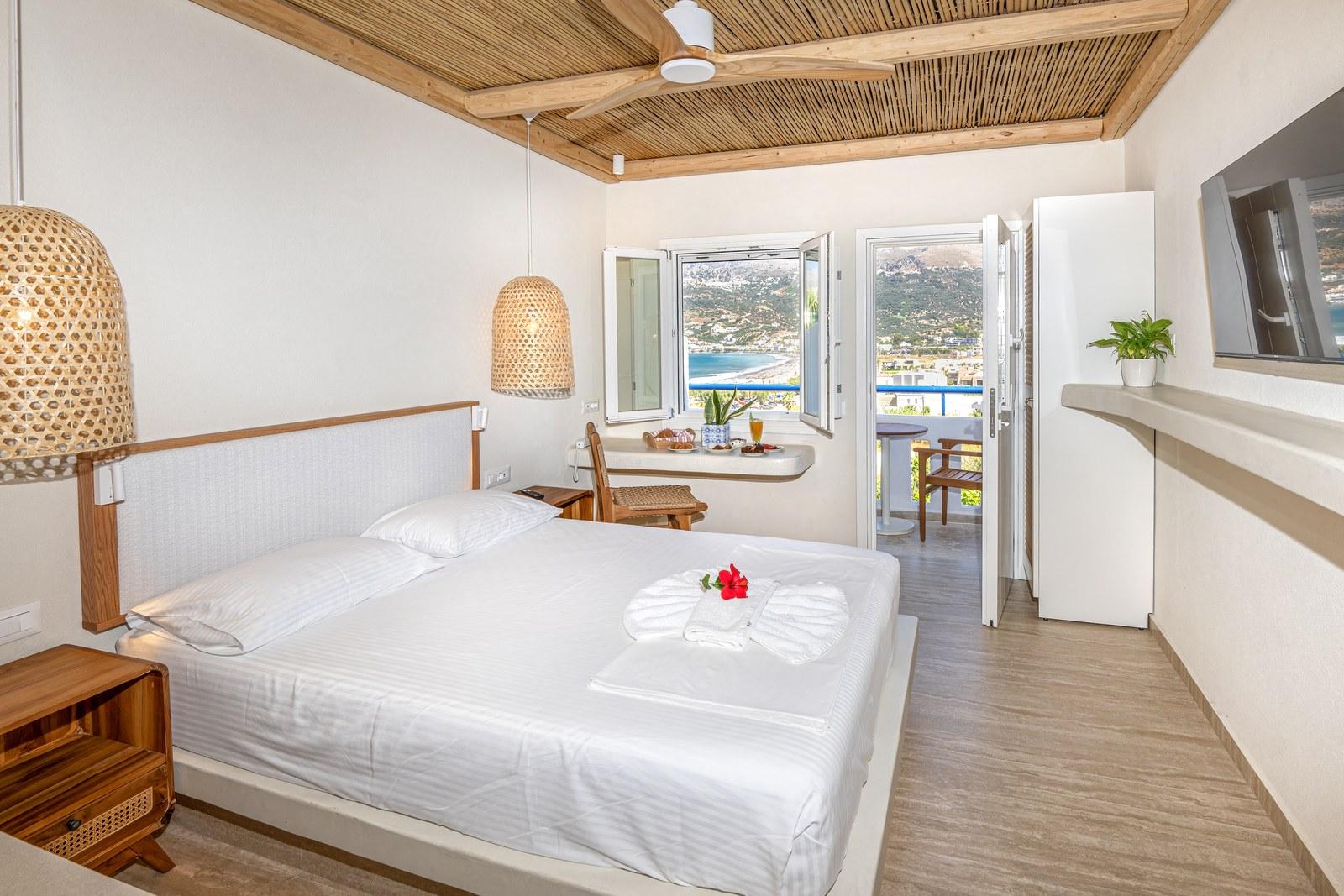 A renovated room at Plakias Bay under its bamboo ceiling