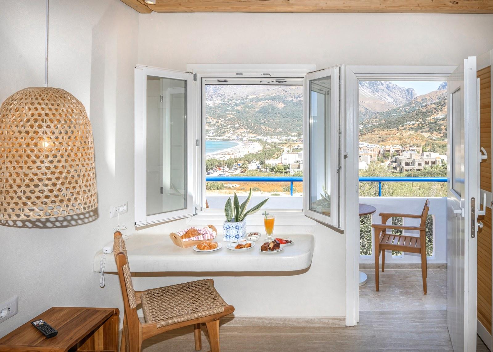 A renovated room at Plakias Bay under its bamboo ceiling